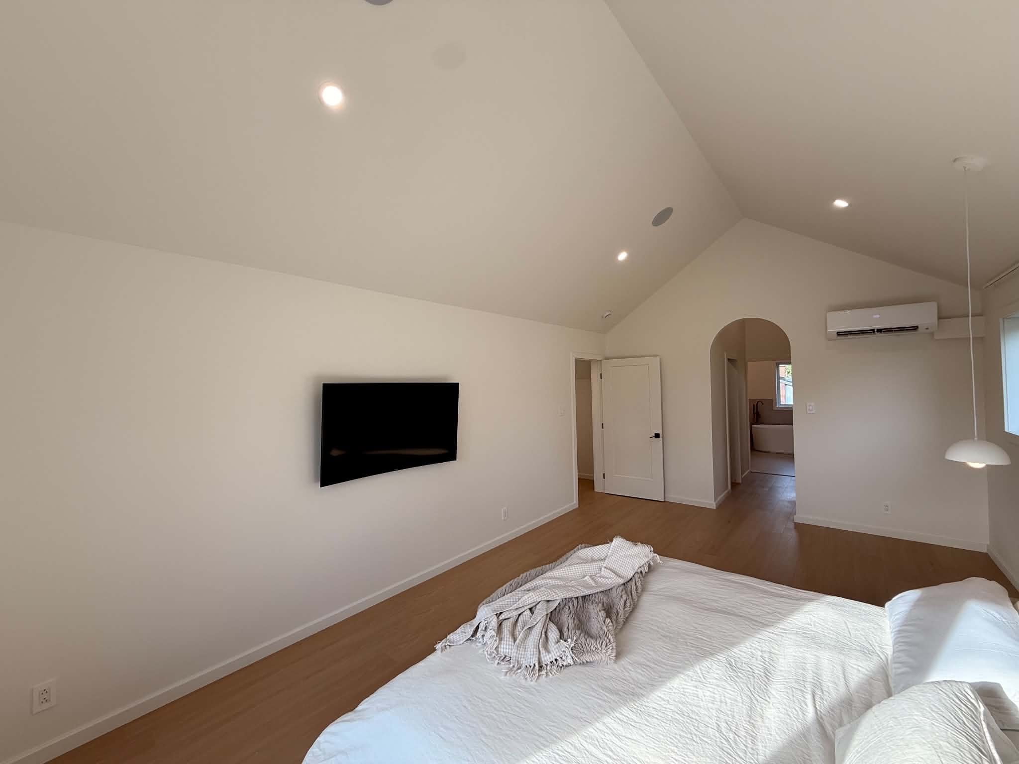 After the work: bedroom and archway opening onto the en-suite bathroom