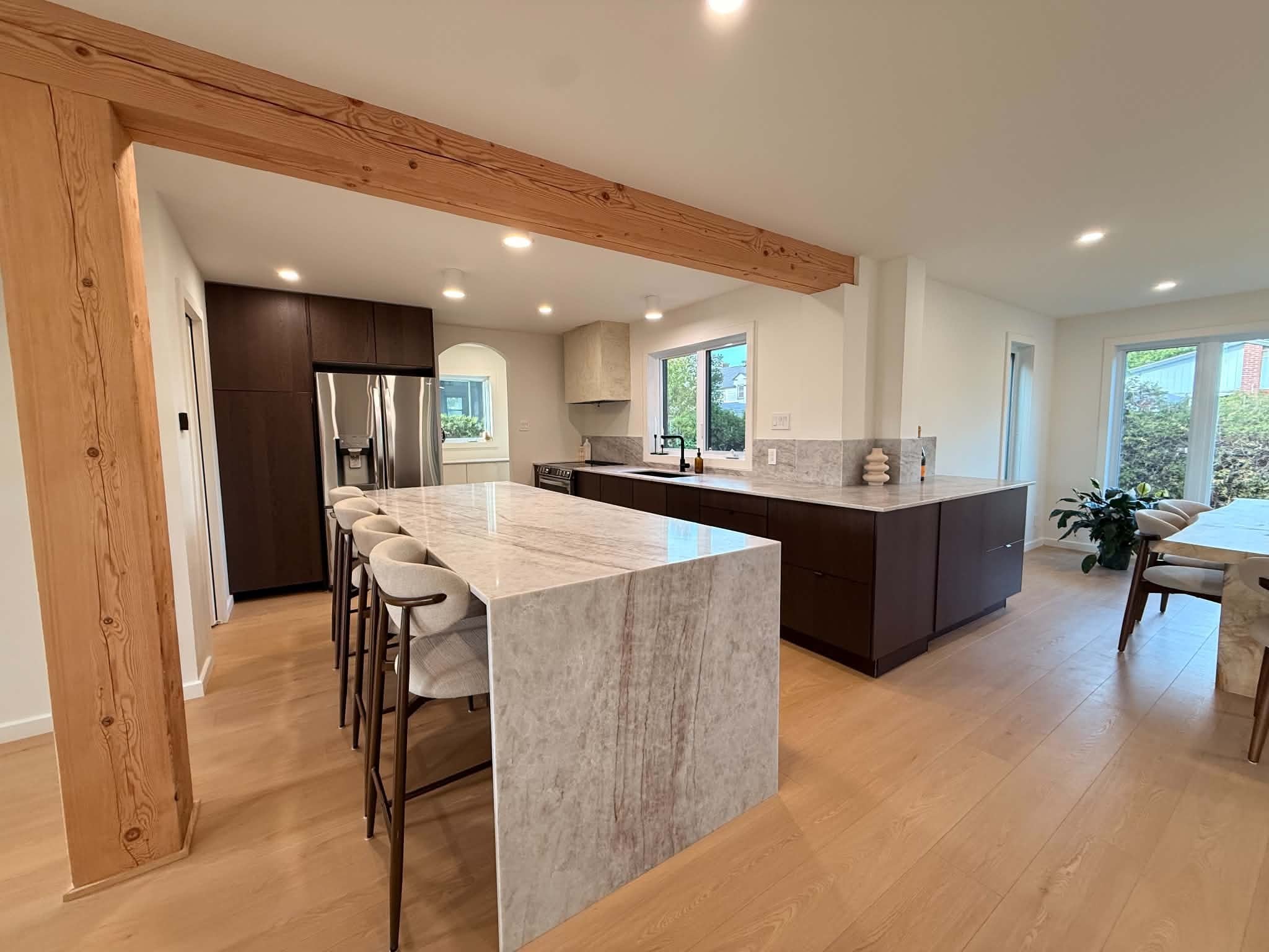 After the work: exposed wood post and beam above the kitchen island