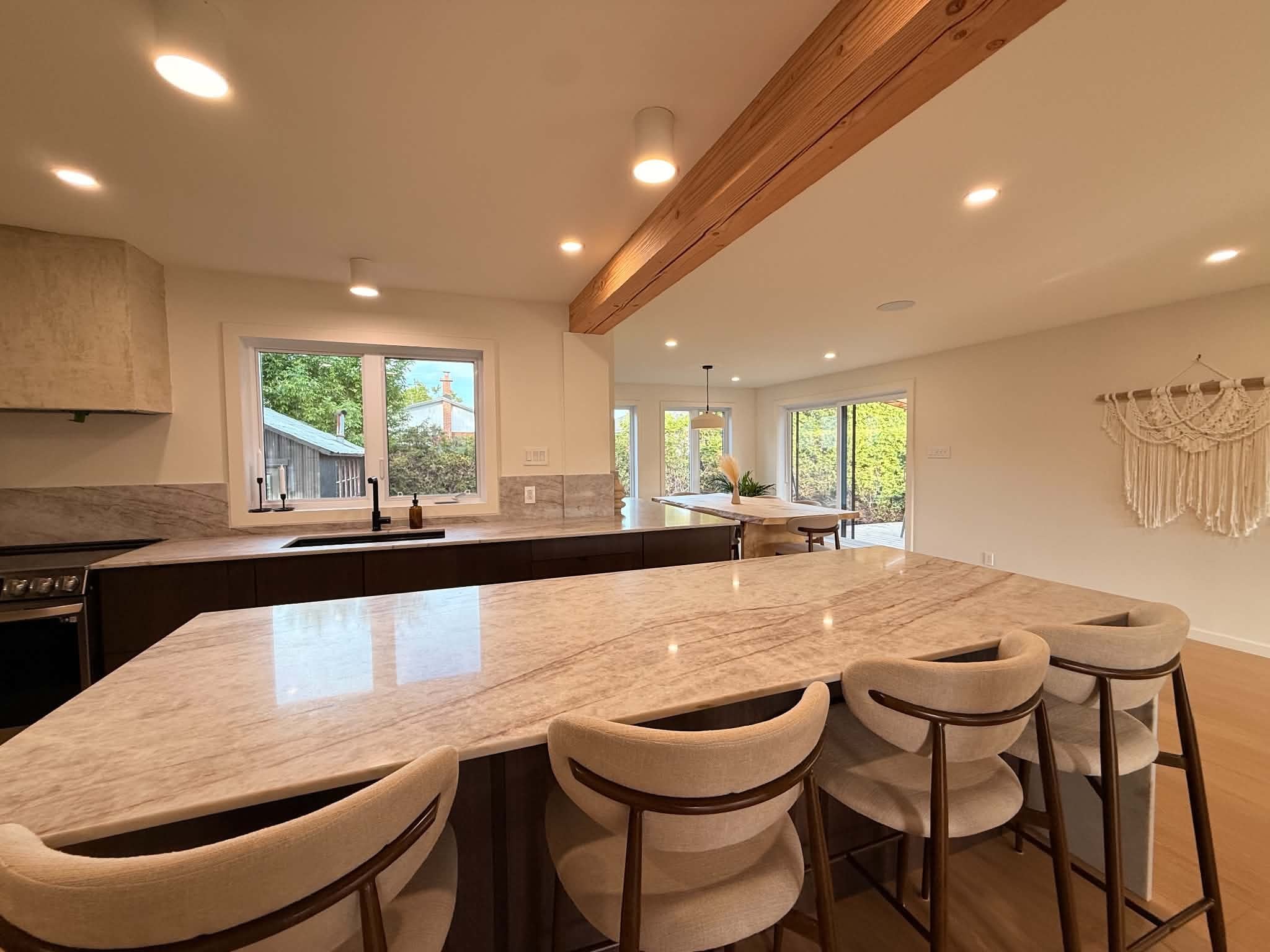 After the work: stone countertop, stools and a window above the sink