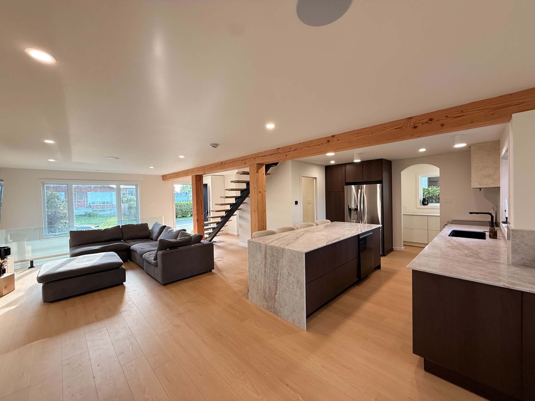 After the work: living room, kitchen island and staircase, seen from the entrance