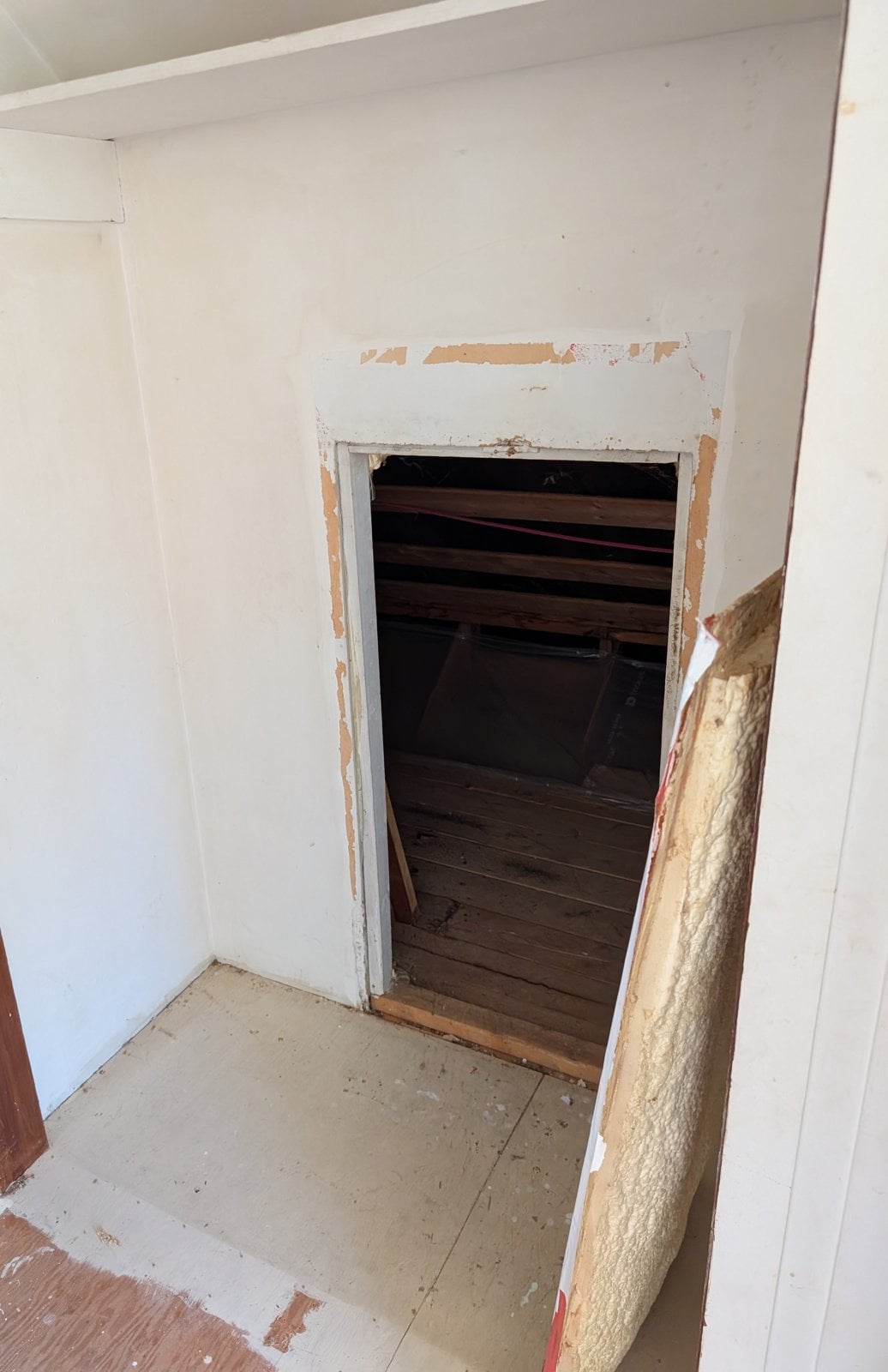 Attic access opening inside a closet, before the work