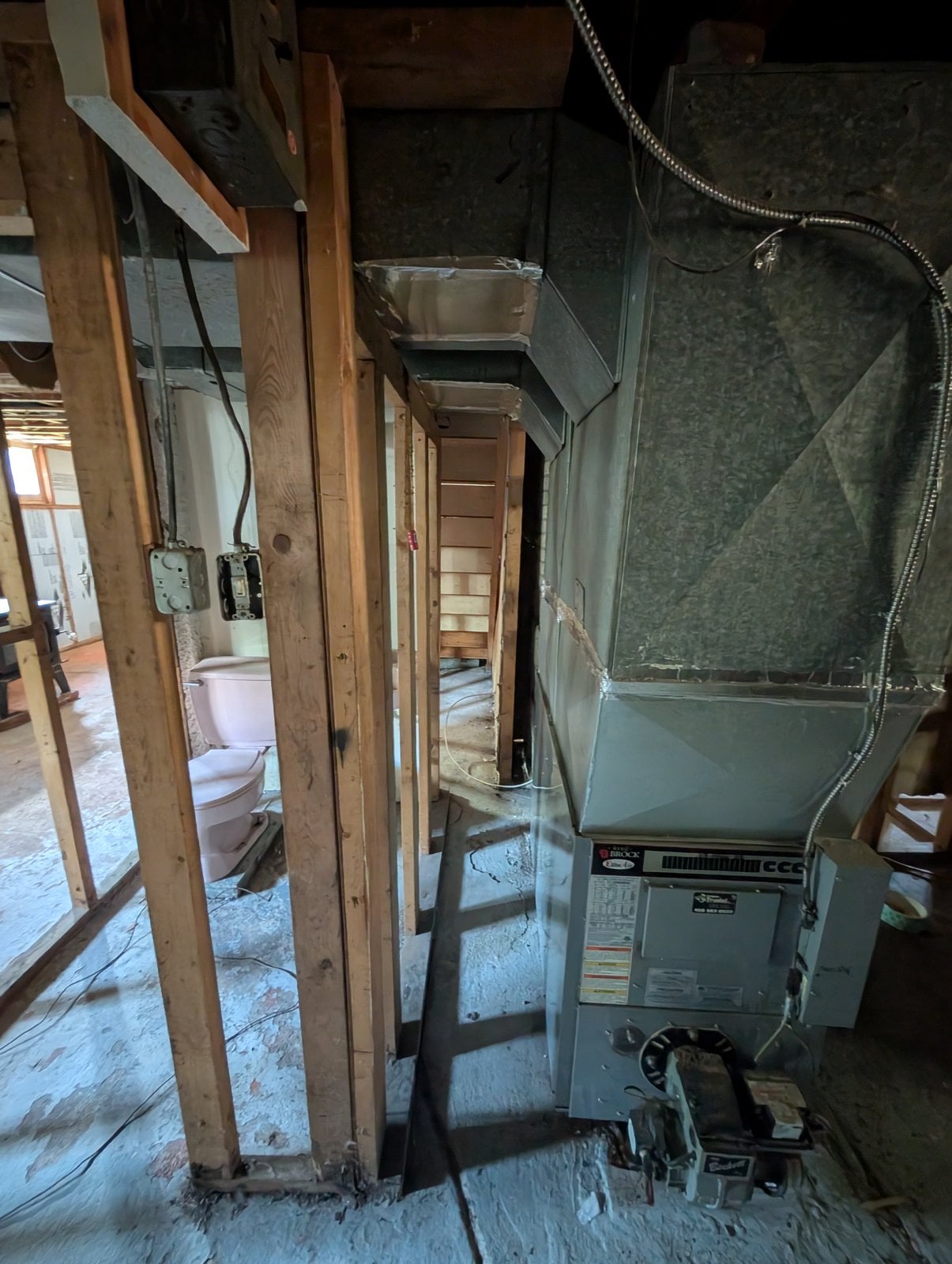 Basement before the work: furnace and ventilation ducts