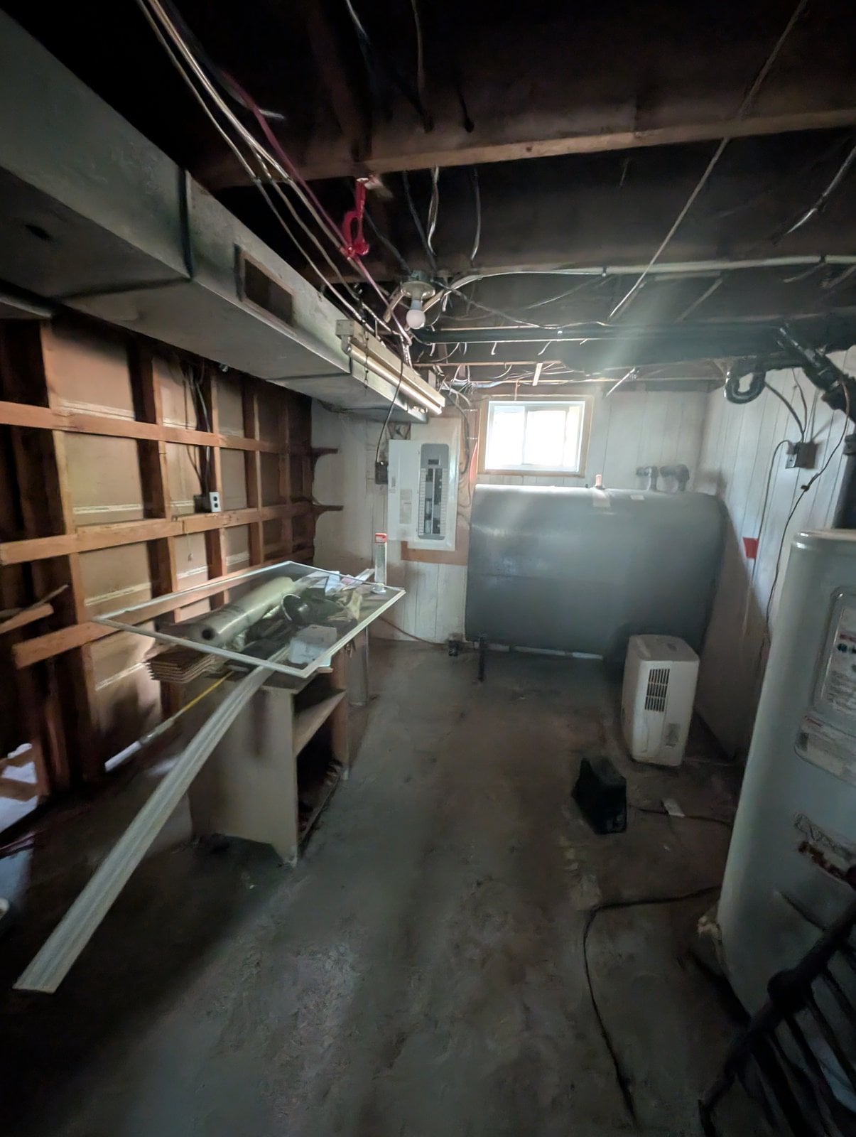 Mechanical room before the work, overall view with ducts in the ceiling