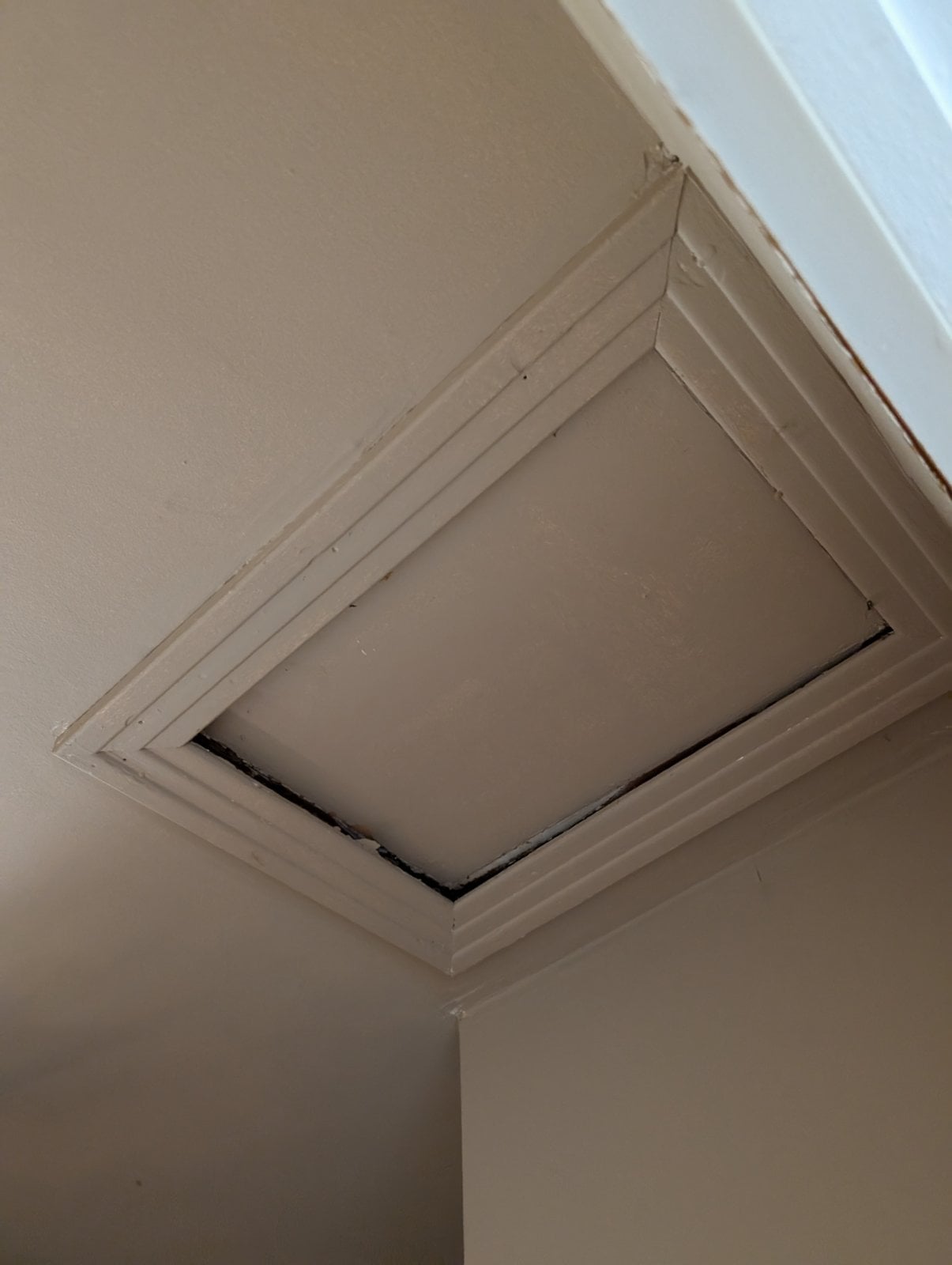 Ceiling hatch giving access to the attic, before the work