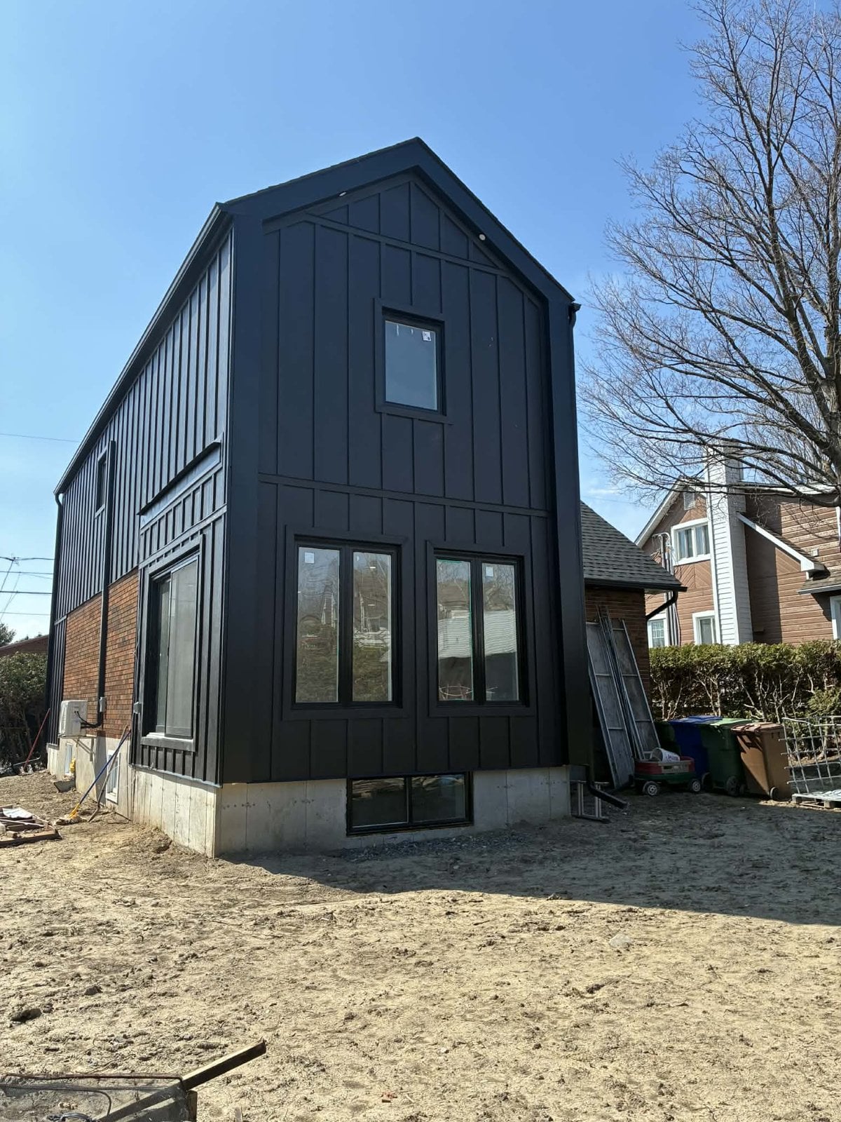 During the work: rear gable of the addition, with large windows and a basement window