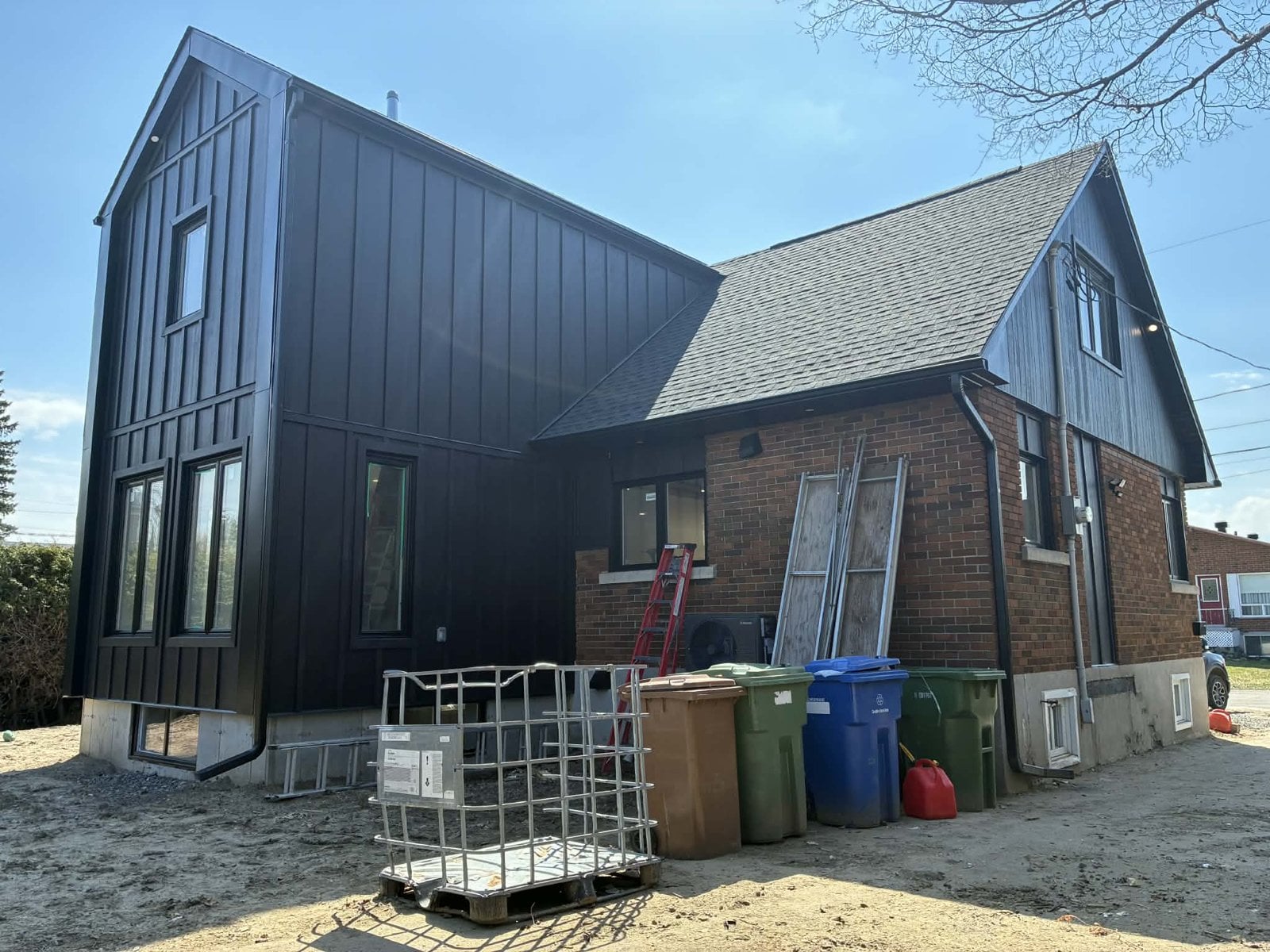 During the work: back of the house, with the black addition and the original brick house