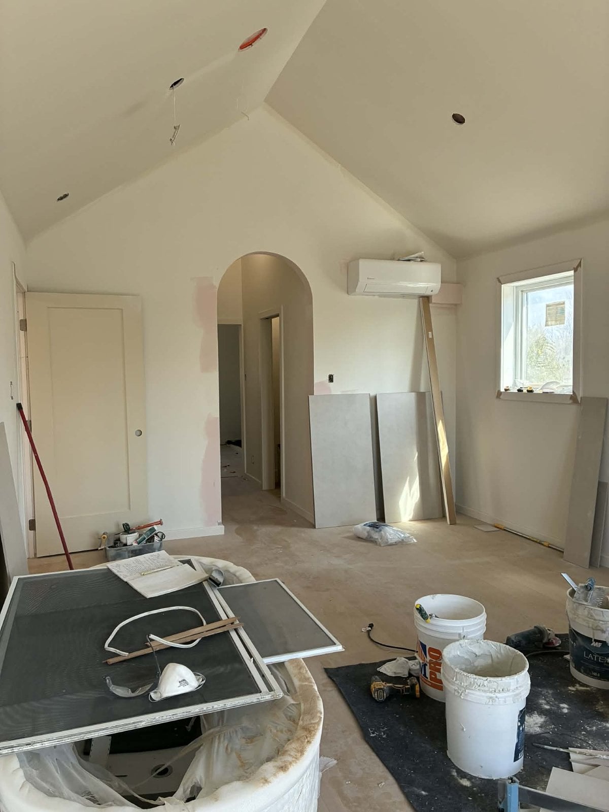 During the work: bedroom under a cathedral ceiling and archway to the bathroom