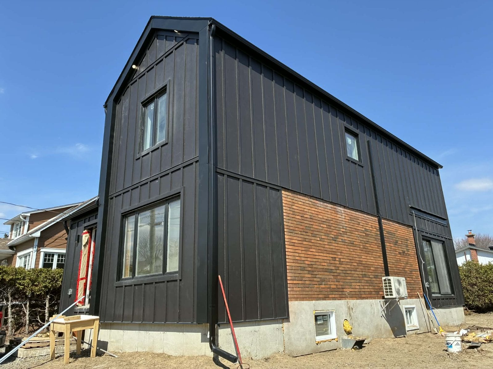 During the work: side of the addition, between black cladding and the original red brick
