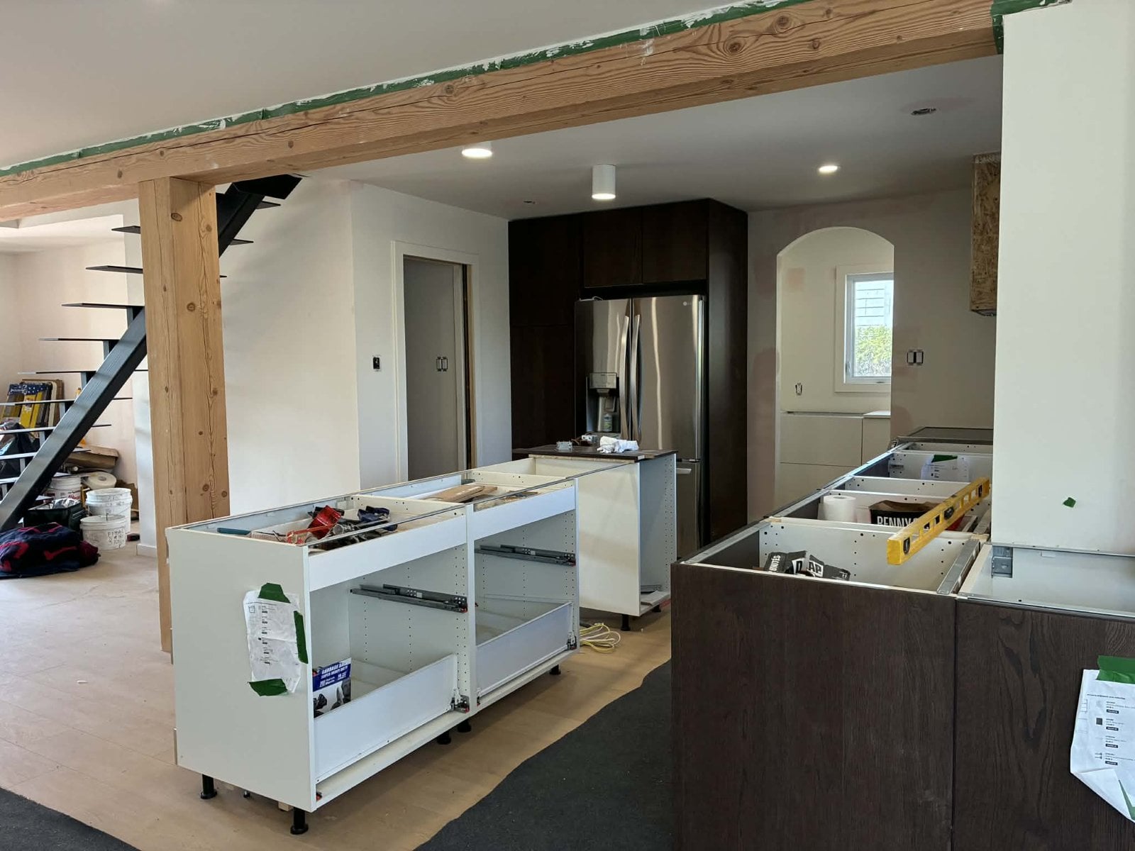 During the work: kitchen island boxes in place and the refrigerator already installed